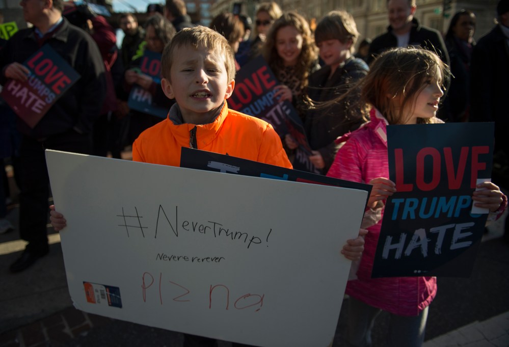 Ten-year-old Henry and seven-year-old Ruby protest outside Verizon Center where Republican presidentil candidate Donald Trump spoke during AIPAC 2016 Policy Conference on March 21, 2016 in Washington, DC. (Photo by Molly Riley/AFP/Getty)
