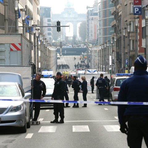 Policemen stand guard near a security perimeter set in the Rue de la Loi near the Maalbeek subway station, in Brussels, on March 22, 2016, after an explosion. (Photo by Nicolas Maeterlinck/AFP/Getty)