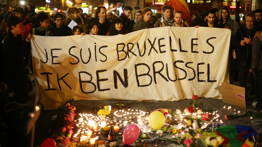 People hold up a banner as a mark of solidarity at the Place de la Bourse following today's attacks on March 22, 2016 in Brussels, Belgium. (Photo by Carl Court/Getty)