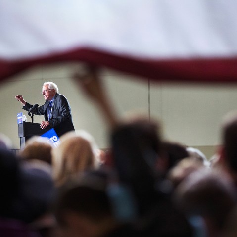 Guests lift up a giant flag to watch Democratic presidential candidate Senator Bernie Sanders (D-VT) speak at a campaign rally at the Alliant Energy Center on March 26, 2016 in Madison, Wis. (Photo by Scott Olson/Getty)