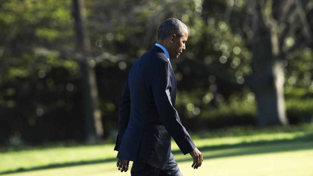 President Barack Obama walks across the South Lawn after arriving on Marine One at the White House in Washington, D.C., March 29, 2016. (Photo by Saul Loeb/AFP/Getty)
