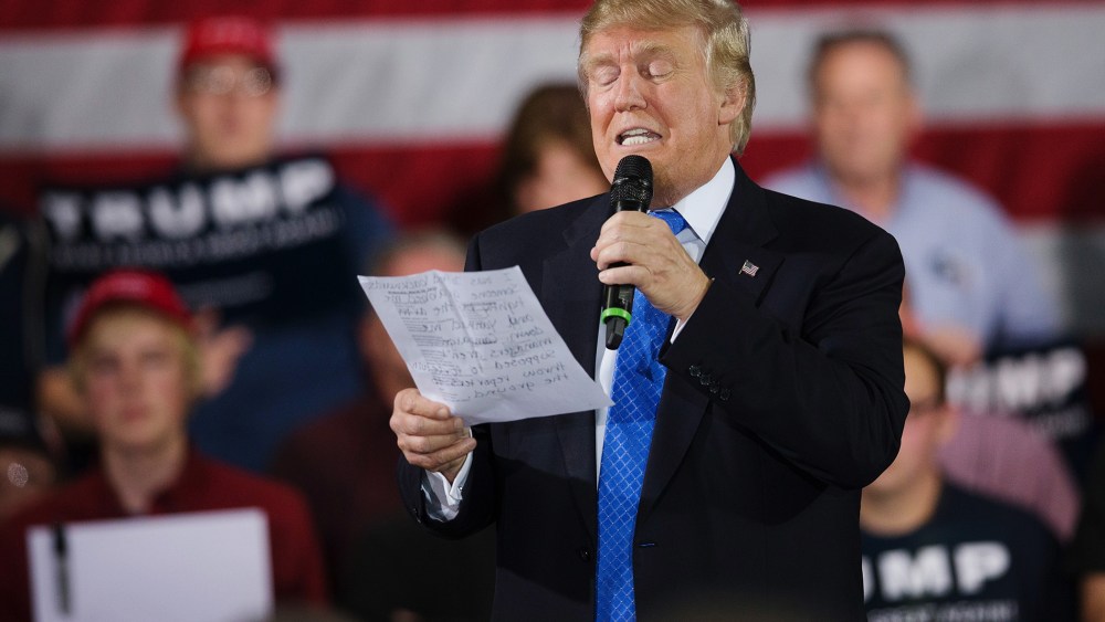 During a campaign rally Republican presidential candidate Donald Trump reads a statement made by Michelle Fields, on March 29, 2016 in Janesville, Wis. (Photo by Scott Olson/Getty)
