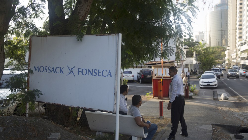 Pedestrians talk near a parking lot outside the building housing the offices of the Mossack Fonseca law firm in Panama City, Panama on April 5, 2016. (Photo by Susana Gonzalez/Bloomberg/Getty)