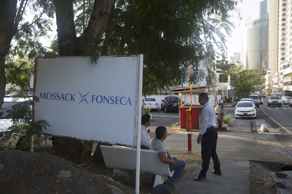 Pedestrians talk near a parking lot outside the building housing the offices of the Mossack Fonseca law firm in Panama City, Panama on April 5, 2016. (Photo by Susana Gonzalez/Bloomberg/Getty)