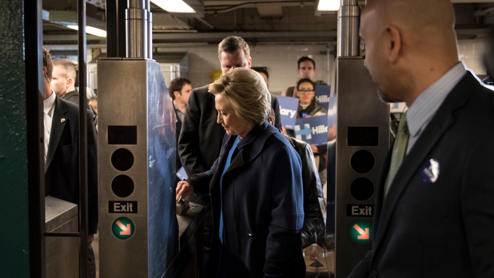 Democratic presidential candidate Hillary Clinton swipes a MetroCard to ride the No. 4 train as she campaigns on April 7, 2016 in the Bronx borough of New York City. (Photo by Andrew Renneisen/Getty)