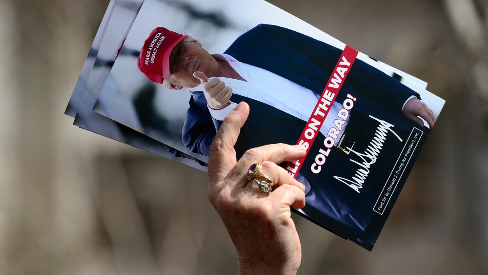 A woman holds leaflets for candidate Donald Trump at the Colorado District 2 meeting, April 8, 2016. (Photo by Kathryn Scott Osler/The Denver Post/Getty)