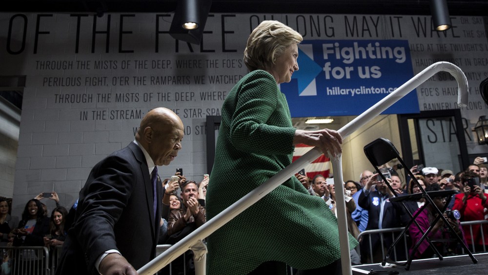Representative Elijah Cummings (D-Md.) and Hillary Clinton, 2016 Democratic presidential candidate, arrive on stage at the start of an event in Baltimore, Md., April 10, 2016. (Photo by Drew Angerer/Bloomberg/Getty)