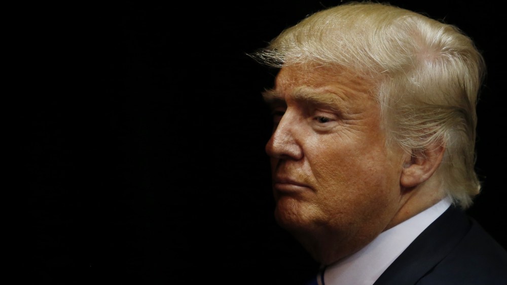 Republican presidential candidate Donald Trump exits the arena after speaking at a campaign rally on April 11, 2016 in Albany, New York. (Photo by Eduardo Munoz Alvarez/Getty)