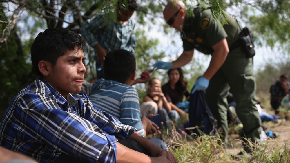 A Border Patrol agent collects personal items from Central American families who crossed into the United States seeking asylum on April 14, 2016 in Roma, Texas. (Photo by John Moore/Getty)