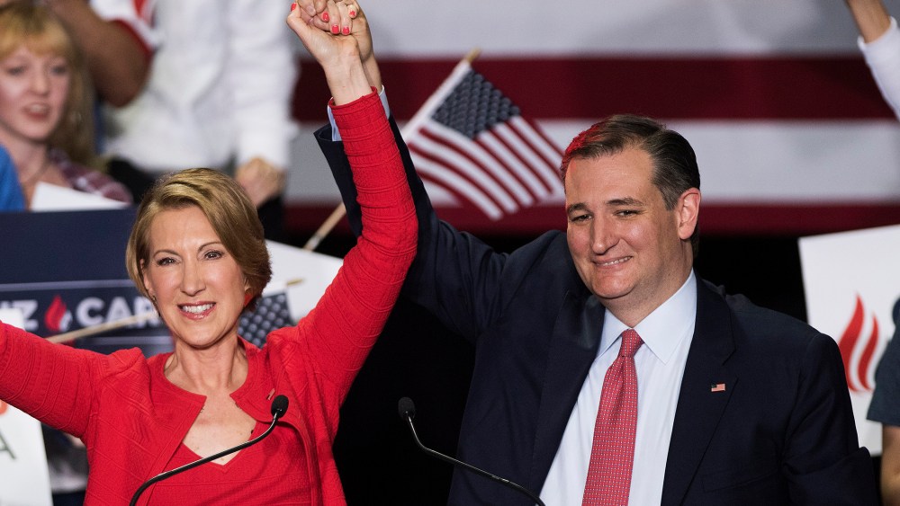 Republican presidential candidate Sen. Ted Cruz (R-TX) holds up hands his new running mate, Carly Fiorina, at a campaign rally at the Pan Am Plaza on April 27, 2016 in Indianapolis, Ind. (Photo by Ty Wright/Getty)