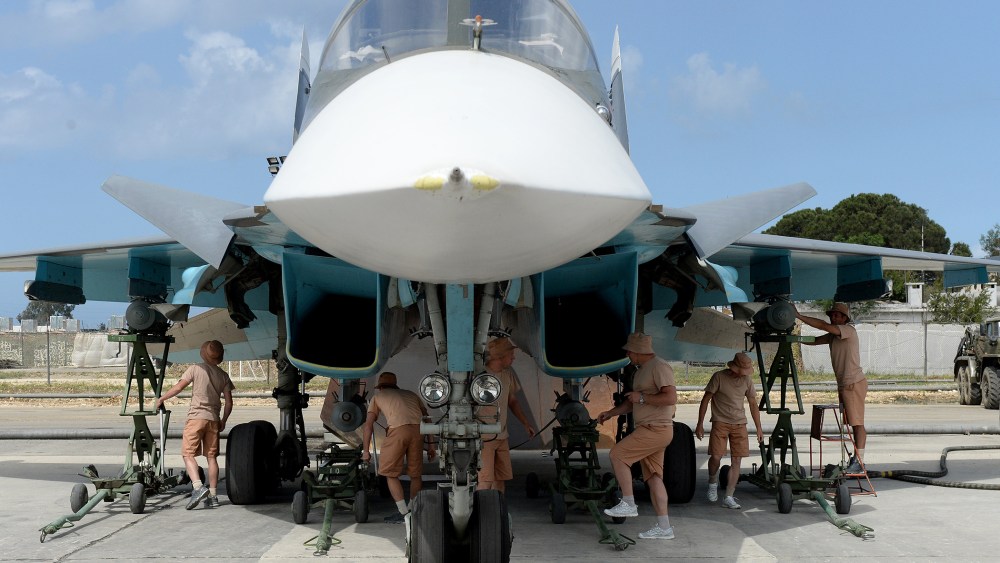 Russian servicemen prepare an SU-34 fighter jet for a mission from the Russian Hmeimim military base in Latakia province, in the northwest of Syria on May 4, 2016. (Photo by Vasily Maximov/AFP/Getty)
