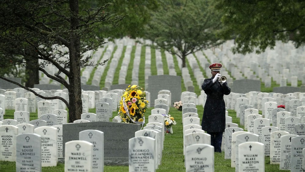 A bugler plays 'Taps' during a funeral at Arlington National Cemetery May 6, 2016 in Arlington, Va. (Photo by Alex Wong/Getty)
