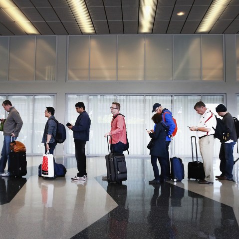 Passengers at O'Hare International Airport wait in line to be screened at a Transportation Security Administration (TSA) checkpoint on May 16, 2016 in Chicago, Ill. (Photo by Scott Olson/Getty)