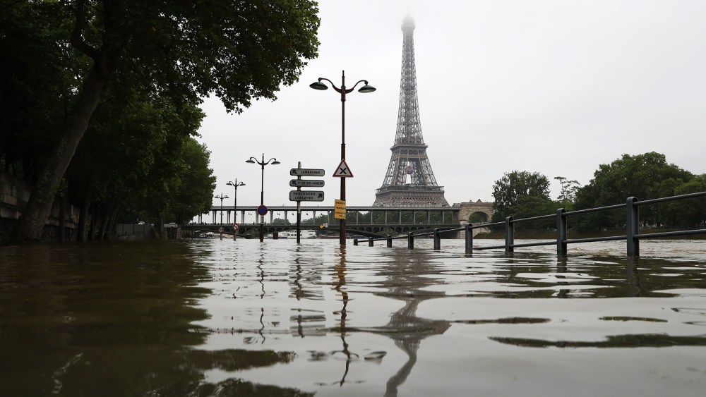 A picture taken on June 2, 2016 shows the river Seine bursting its banks next to the Eiffel Tower in Paris. (Photo by Kenzo Tribouillard/AFP/Getty)
