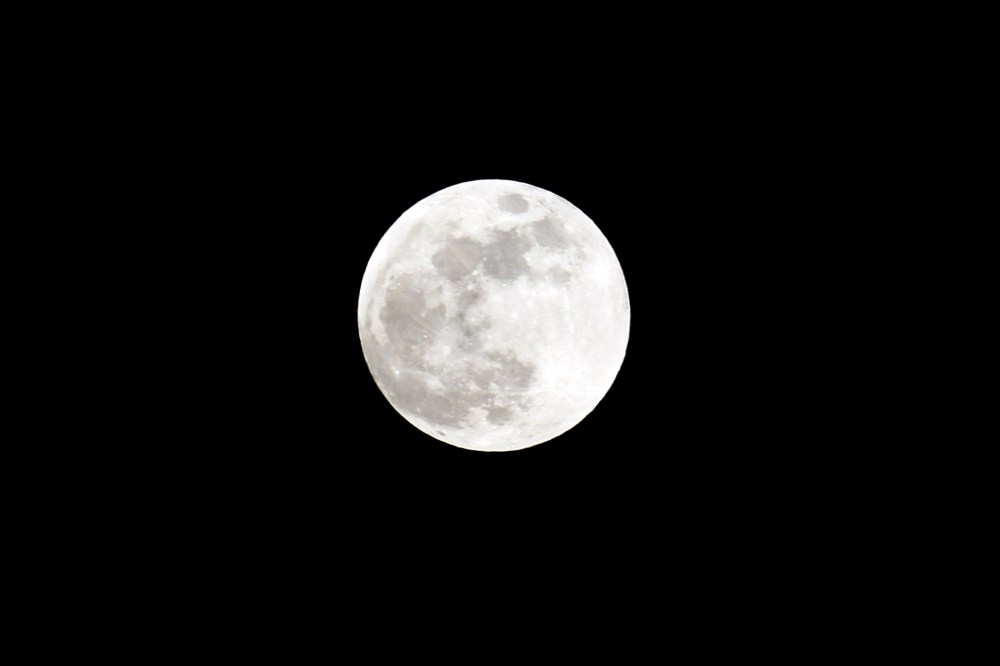 A full moon sits in the nights sky. (Photo by Lars Baron/Getty)