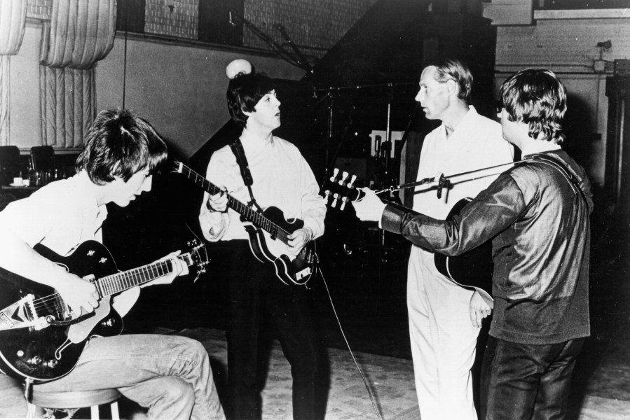 Rock and roll band 'The Beatles' pose for a portrait in the studio with their producer George Martin in circa 1964. (L-R) George Harrison, Paul McCartney, George Martin, John Lennon. (Photo by Michael Ochs Archives/Getty)