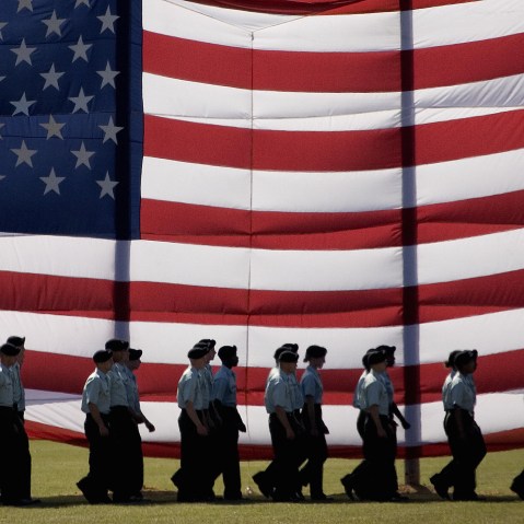 Troops march past a large American flag as they graduate from Basic Combat Training at Fort Jackson, S.C., Nov. 2, 2007. (Photo by Paul J. Richards/AFP/Getty)