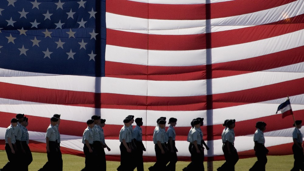 Troops march past a large American flag as they graduate from Basic Combat Training at Fort Jackson, S.C., Nov. 2, 2007. (Photo by Paul J. Richards/AFP/Getty)