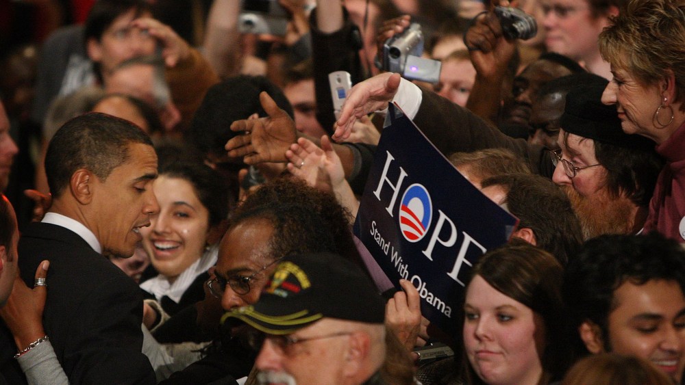 Then-Democratic Presidential hopeful Senator Barack Obama (D-IL) greets supporters gathered for a post-caucus celebration at the Hy-Vee Center, Jan. 3, 2008 in Des Moines, Ia. (Photo by Scott Olson/Getty)