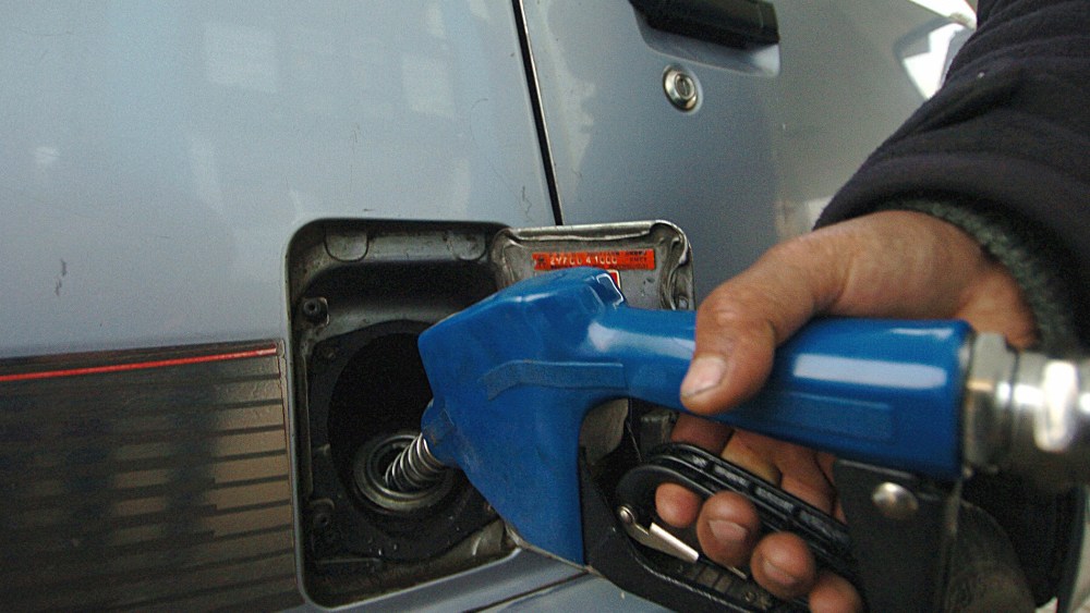 An Afghan fuel station employee fills the tank of a car. (Photo by Shah Marai/AFP/Getty)