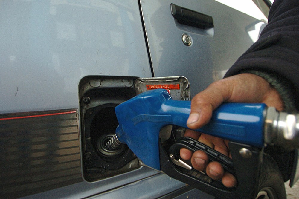An Afghan fuel station employee fills the tank of a car. (Photo by Shah Marai/AFP/Getty)