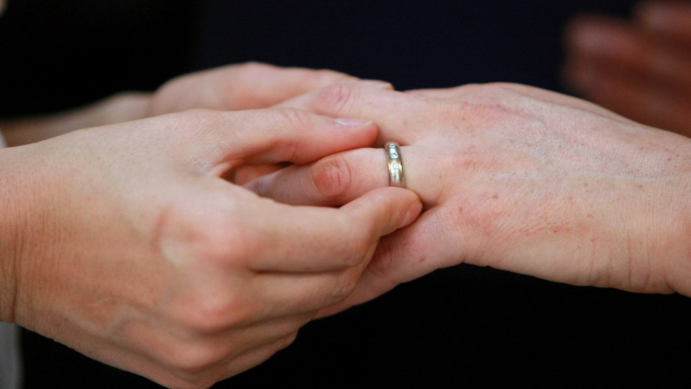 Same-sex couple exchange rings during their wedding ceremony (Photo by Justin Sullivan/Getty).