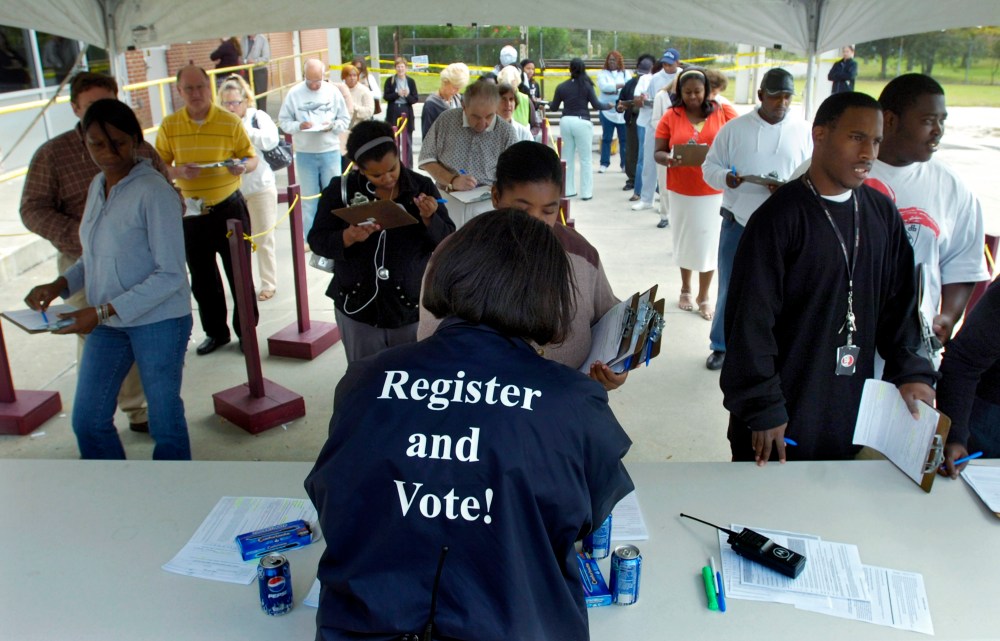 Board of Elections Customer Service Supervisor Sabrina German hands out absentee ballots during early voting Oct. 23, 2008 in Savannah, Ga. (Photo by Stephen Morton/Getty)