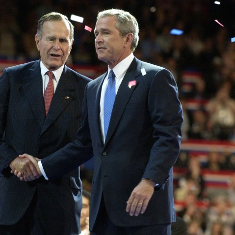 Former President George Herbert Walker Bush, left, congratulates his son, then current US President George W. Bush during the final session of the Republican National Convention in New York, Sept. 2, 2004. (Photo by Mike Mergen/Bloomberg/Getty)