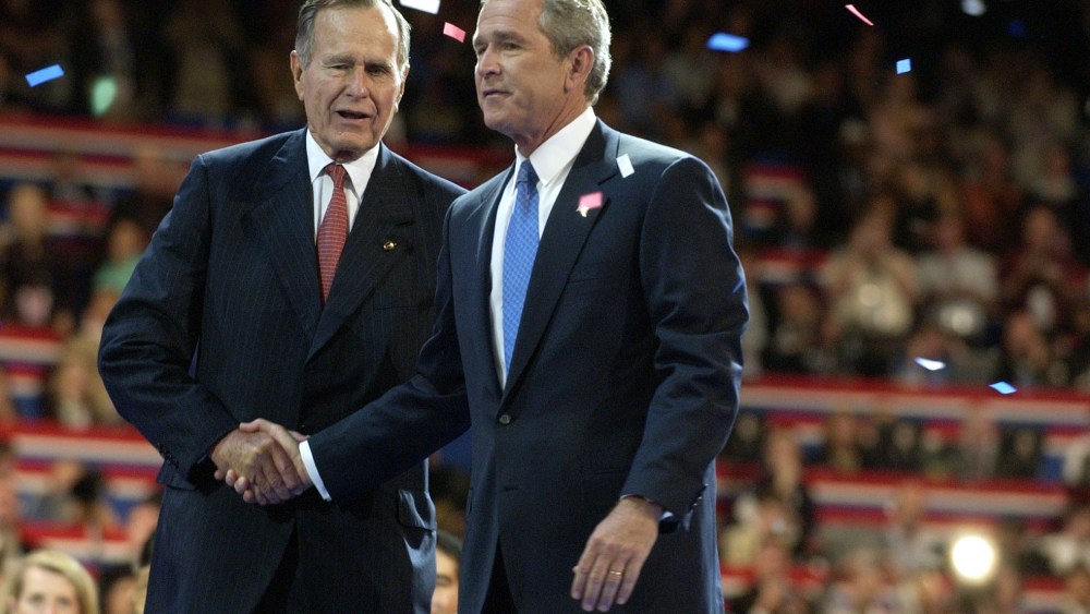 Former President George Herbert Walker Bush, left, congratulates his son, then current US President George W. Bush during the final session of the Republican National Convention in New York, Sept. 2, 2004. (Photo by Mike Mergen/Bloomberg/Getty)