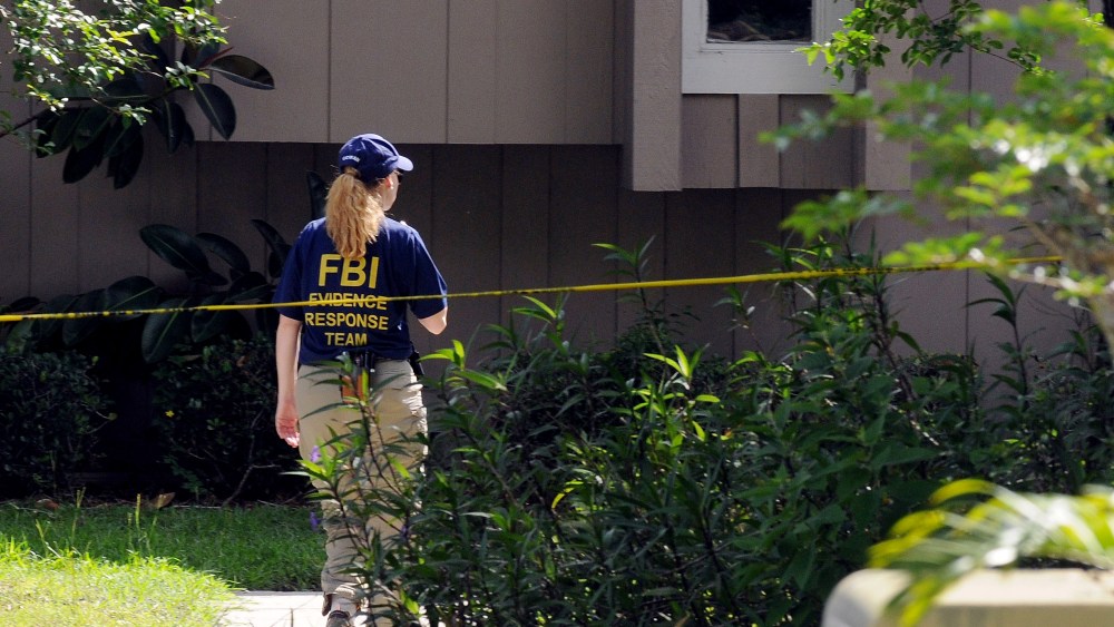 A Federal Bureau of Investigation (FBI) evidence response agent works outside an apartment complex where a suspected friend of the Boston bombers was shot and killed by FBI on May 22, 2013 in Orlando, Fl. (Photo by Gerardo Mora/Getty)