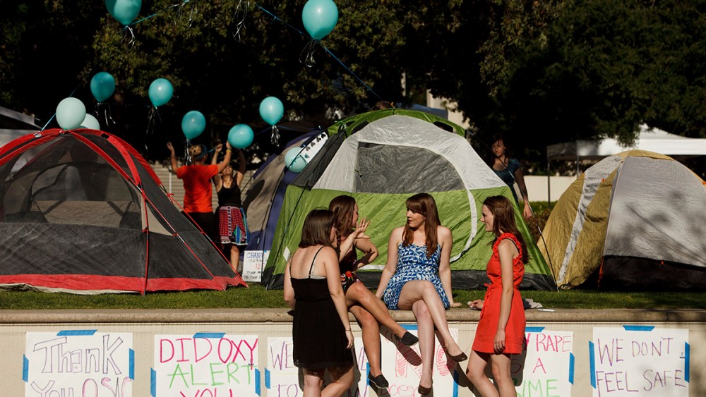 Carly Mee, a student at Occidental College, center, talks with other students during the Oxy Sexual Assault Coalition (OSAC) sexual assault awareness night campout at the college campus in Los Angeles, California, U.S., on Friday, April 19, 2013.