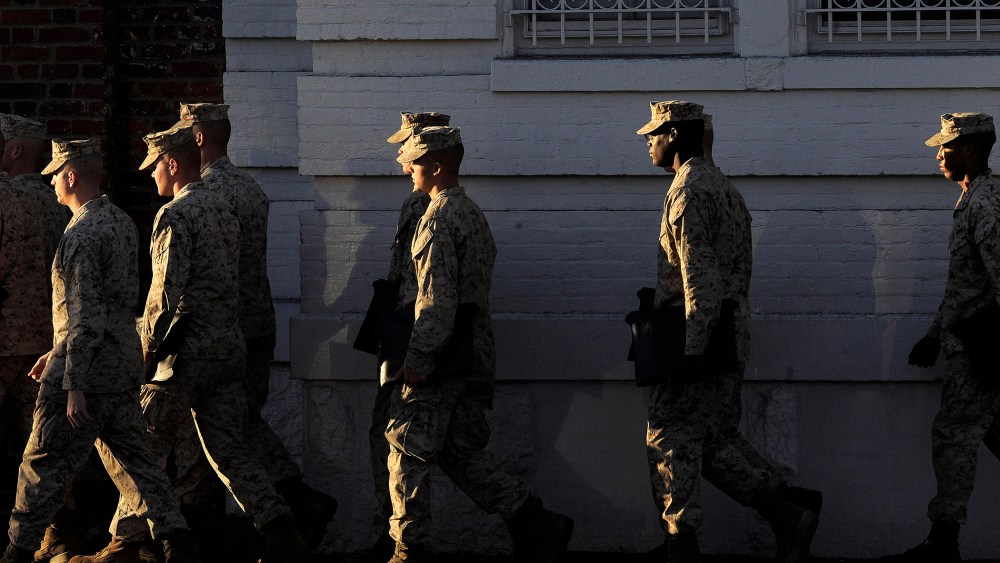 Military personnel walk by the Washington Navy Yard on Sept 17, 2013 in Washington, DC.