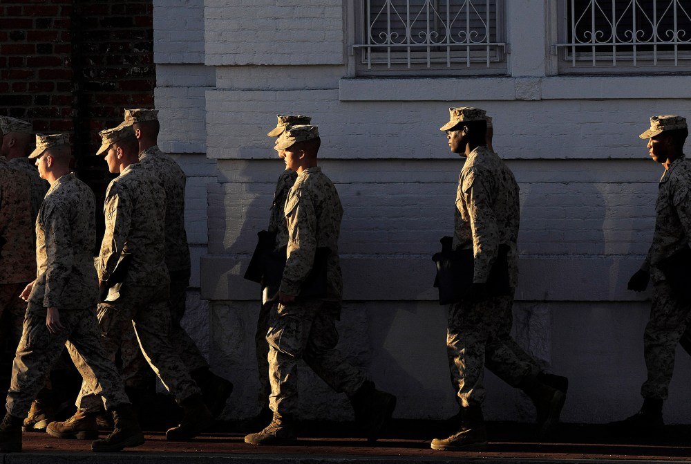 Military personnel walk by the Washington Navy Yard on Sept 17, 2013 in Washington, DC.