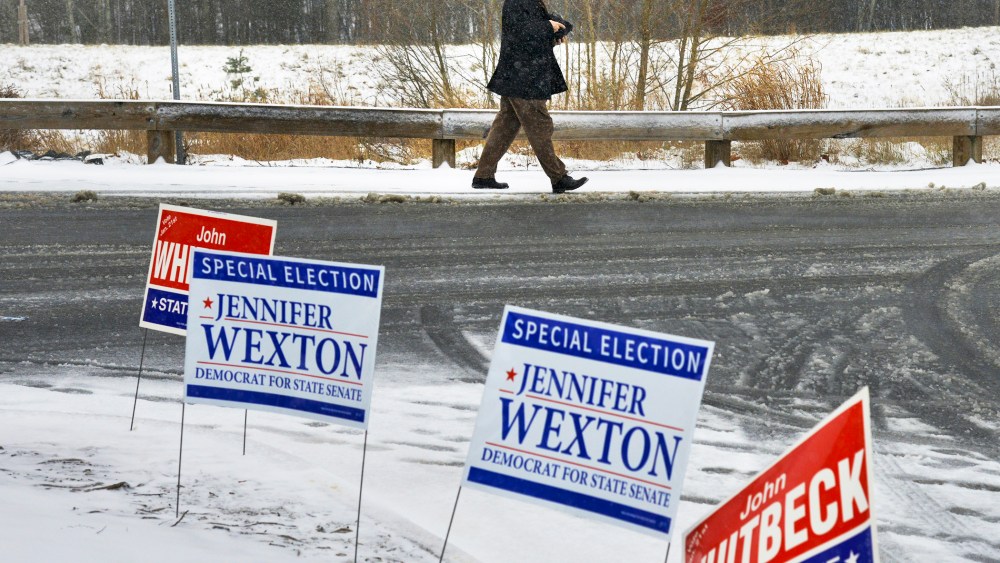 A voter leaves a polling station in Sterling, VA., during the special election for the Virginia 33rd state senate seat, Jan. 21, 2014.