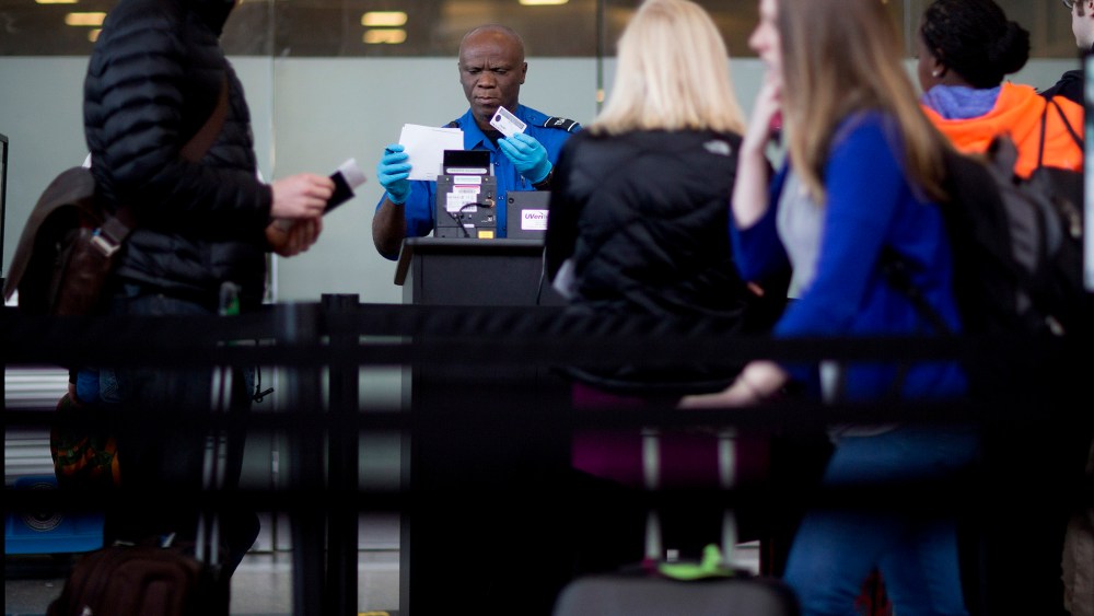 A Transportation Security Administration (TSA) officer checks a passenger's identification and boarding pass at a security checkpoint at Ronald Reagan National Airport in Washington, D.C., U.S., on Feb. 25, 2015. (Photo by Andrew Harrer/Bloomberg/Getty)