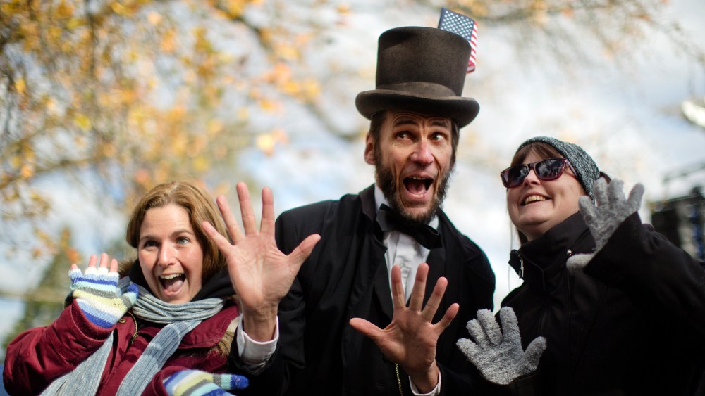 Rick Miller a President Abraham Lincoln re-enactor poses for photographs after a ceremony commemorating the 150th anniversary of the dedication of the Soldiers National Cemetery and President Abraham Lincoln's Gettysburg Address, Tuesday, Nov. 19, 2013,