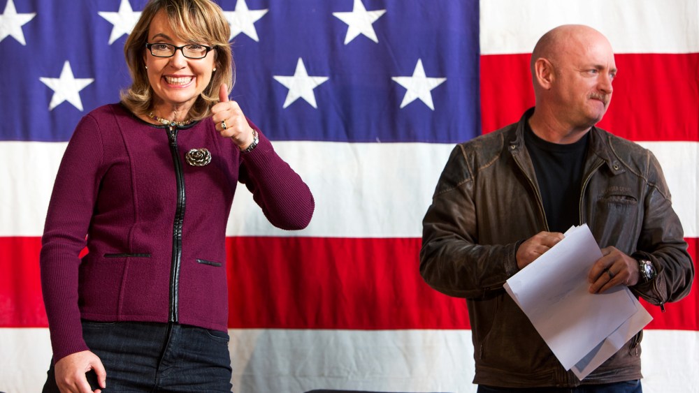 Gabby Giffords and her husband Mark Kelly are introduced at a fundraiser for U.S. Senate candidate Bruce Braley, Sunday, Oct. 27, 2013, in Des Moines, Iowa.
