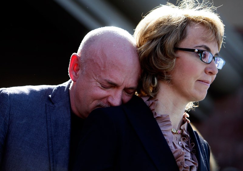 Mark Kelly leans his head on the shoulder of his wife and former congresswoman Gabby Giffords at a in Tucson, Arizona on March 6, 2013. (Photo by Joshua Lott/Getty Images)