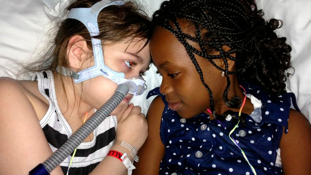 In this May 30, 2013 photo provided by the Murnaghan family, Sarah Murnaghan, left, lies in her hospital bed next to adopted sister Ella on the 100th day of her stay in Children's Hospital of Philadelphia. The 10-year-old suburban Philadelphia girl has...