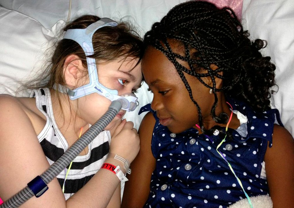 In this May 30, 2013 photo provided by the Murnaghan family, Sarah Murnaghan, left, lies in her hospital bed next to adopted sister Ella on the 100th day of her stay in Children's Hospital of Philadelphia. The 10-year-old suburban Philadelphia girl has...