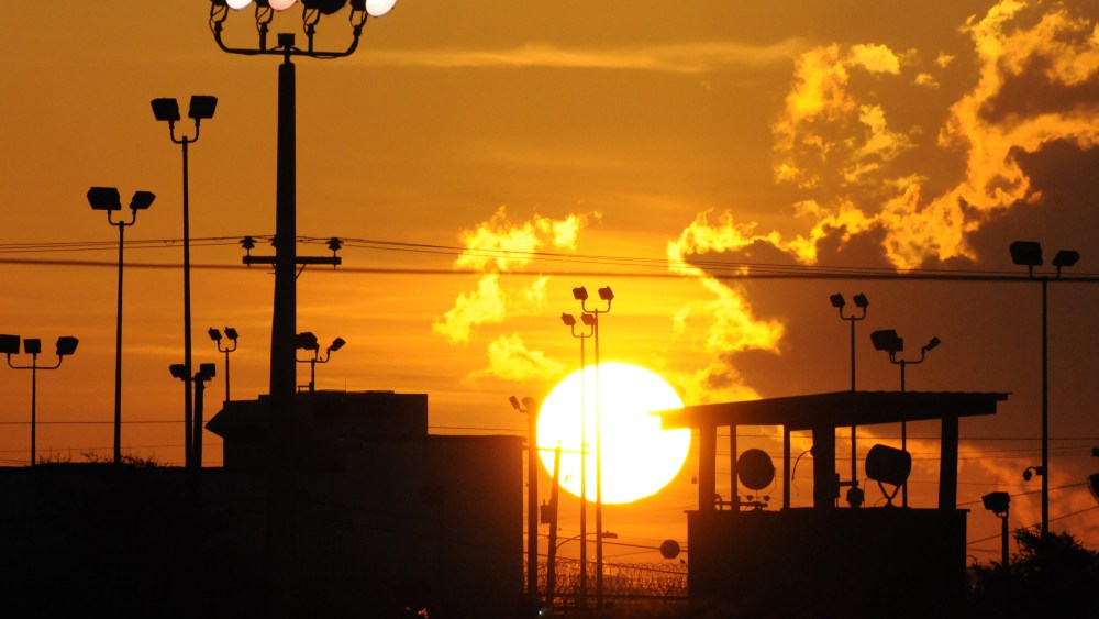 In this photo reviewed by the U.S. Department of Defense, towers overlooking a U.S. detention facility are silhouetted against a morning sunrise at Guantanamo Bay U.S. Naval Base, Cuba, Thursday, Oct. 18, 2012.  (AP Photo/Toronto Star, Michelle...