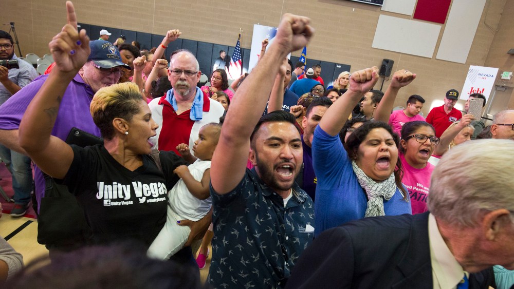 Activists including A.J. Buhay, center, chant "Black lives matter" at the end of Republican presidential candidate Jeb Bush's town hall meeting at the Pearson Community Center in North Las Vegas, Nev., Aug. 12, 2015. (Steve Marcus/Las Vegas Sun/AP)