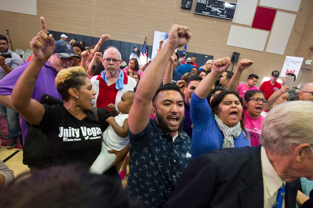 Activists including A.J. Buhay, center, chant "Black lives matter" at the end of Republican presidential candidate Jeb Bush's town hall meeting at the Pearson Community Center in North Las Vegas, Nev., Aug. 12, 2015. (Steve Marcus/Las Vegas Sun/AP)
