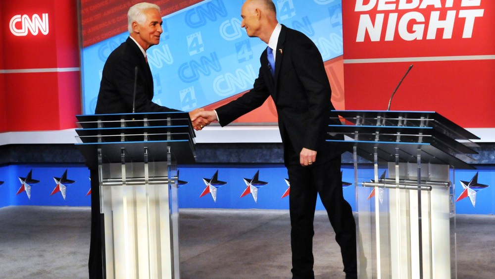 Democratic candidate Charlie Crist, left, and Republican Gov. Rick Scott shake hands before their live television debate on Oct. 21, 2014 in Jacksonville, Fla.