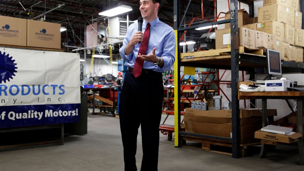 Republican Wisconsin Gov. Scott Walker campaigns for re-election at a manufacturing company in Racine, Wis. on Sept. 23, 2014.