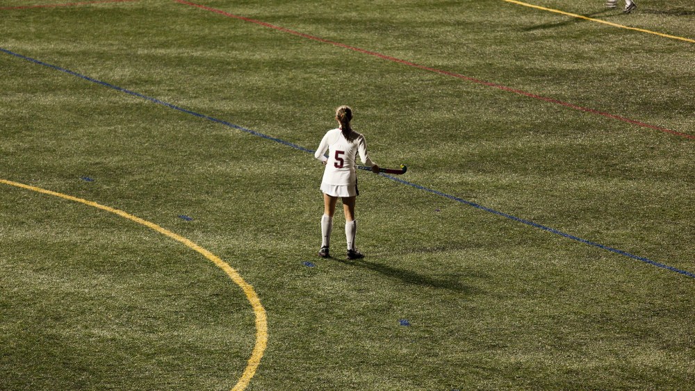 Woman playing field hockey.