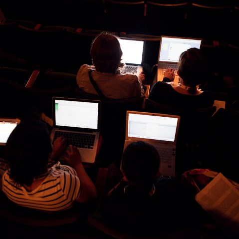 People work on their laptops while attending a lecture. (Photo by Martin Adolfsson/Gallery Stock)