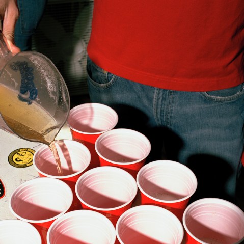 A college student fills cups With beer. (Photo by Brian Finke/Gallery Stock