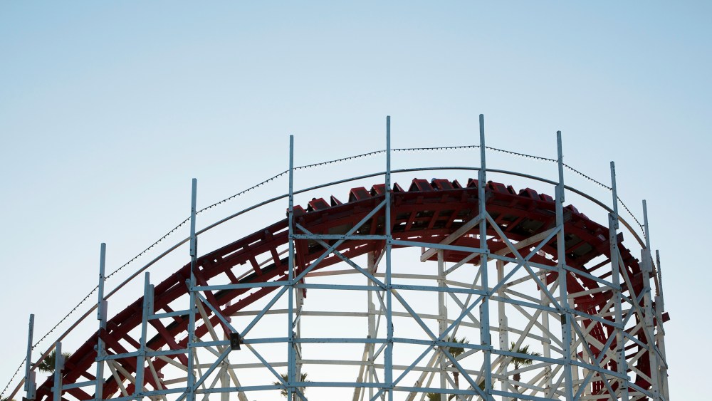 Roller coaster cars turn on a curve. (Photo by Stephen Tamiesie/Gallery Stock)