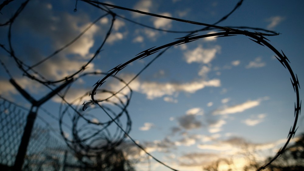 In this photo reviewed by the U.S. military, concertina wire hangs off a fence in the now abandoned Camp X-Ray, which was used as the first detention facility for al-Qaida and Taliban militants who were captured after the Sept. 11 attacks at Guantanamo Ba